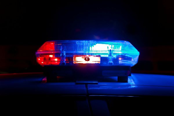 A police light bar flashing red and blue at night