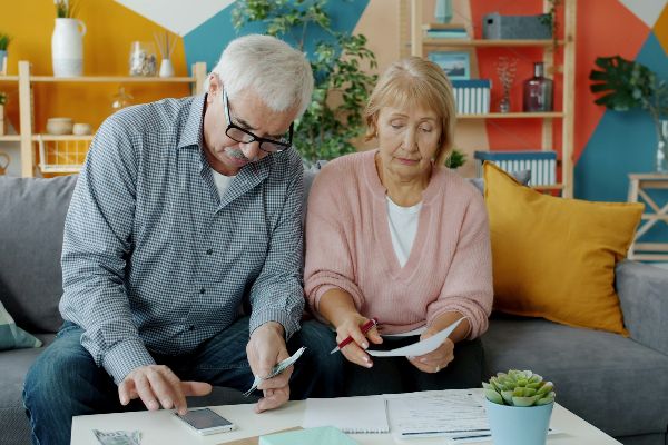 An older couple reviewing paperwork together at home