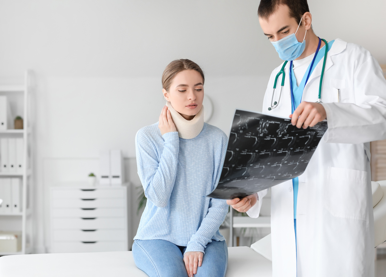 Young Woman with Injury of Neck Visiting Doctor in Clinic
